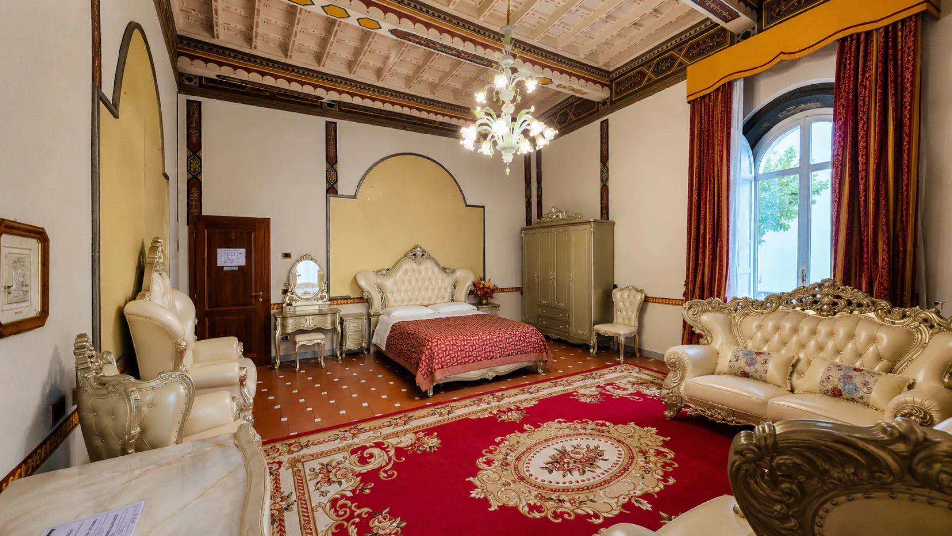 Una suite della villa, con il letto matrimoniale e le finestre sul parco